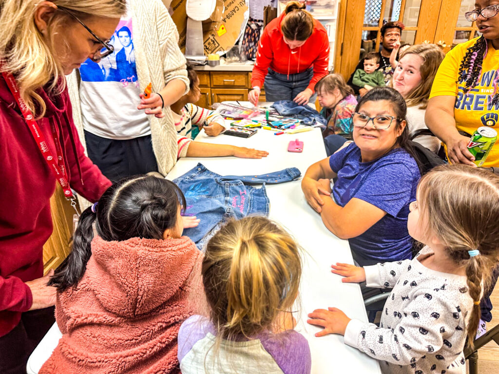 St. Ann Center clients celebrate Global Intergenerational Week by teaming up to make custom denim jackets.